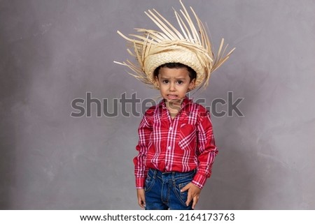 cute little boy wearing typical clothes for Festa Junina with copy space