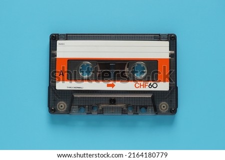 Audio cassette tape isolated on blue background, Vintage retro gadgets for The 70-80-90's Royalty-Free Stock Photo #2164180779