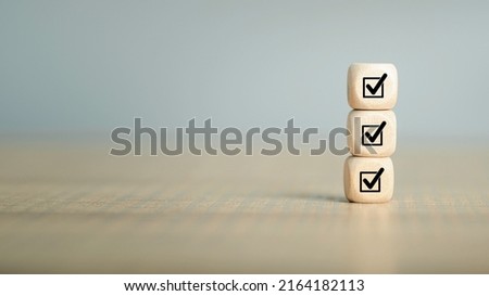 Checklist, Corporate regulatory and compliance, approve, Quality control management, ISO certification, service quality warranty concept. Check mark icon on wooden cube blocks with copy space. Royalty-Free Stock Photo #2164182113