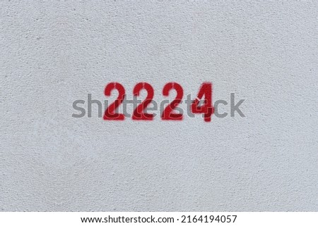 Red Number 2224 on the white wall. Spray paint.
