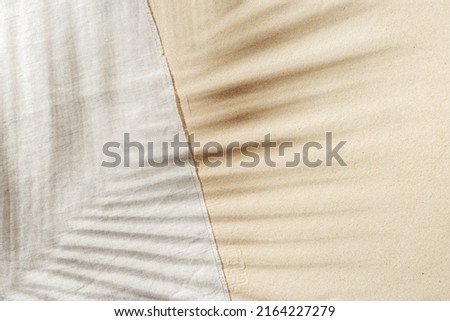 Summer background, top view beach towel on sand with  sun shadow from palm leaf. Summer aesthetic photo pale beige colored, copy space, nobody, vacation and relaxation concept. Top view sandy beach. Royalty-Free Stock Photo #2164227279