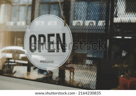 We Are Open, coffee cafe shop text on vintage sign board hanging on glass door in cafe shop reopen after coronavirus quarantine is over in restaurant ready to service, small business owner concept