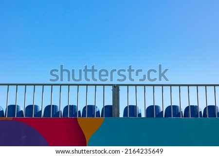 Empty or vacant seats on the top of the stadium with clear sky on background. Protesting the team or banning from the sport concept photo.