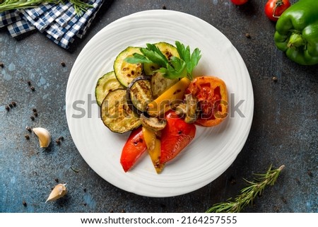 grilled vegetables on a plate top view on blue table Royalty-Free Stock Photo #2164257555
