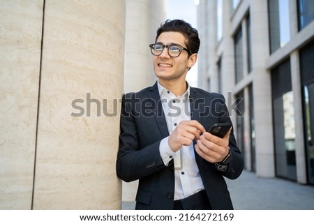 Uses a phone from a businessman a man in a business suit goes to work in the office