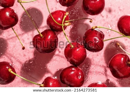 Cherry concept in modern style on pink background with shadows, wallpaper, top view. Horisontal orientation Royalty-Free Stock Photo #2164273581