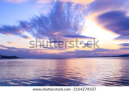 sea ​​sunset landscape, purple, blue tones of the sky, clouds, calmness, harmony, peace, meditation, magical state of nature, background, space for text, evening landscape, beauty, reflection