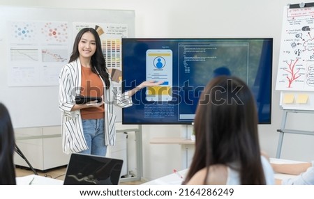 Business woman present project form monitor and tablet Startup team working in office, business teamwork Meeting Present UX UI Royalty-Free Stock Photo #2164286249
