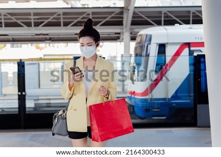 Asian women Thai people shopping in malls on vacation live a new normal in the capital travel in the capital Epidemic Prevention in Bangkok, Thailand Royalty-Free Stock Photo #2164300433