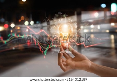 Energy crisis, Hand hold light bulb with energy resources icon and rising data chart representing electricity crisis, Economy   and alternative energy, Sustainability. Ecological friendly.  Royalty-Free Stock Photo #2164312189