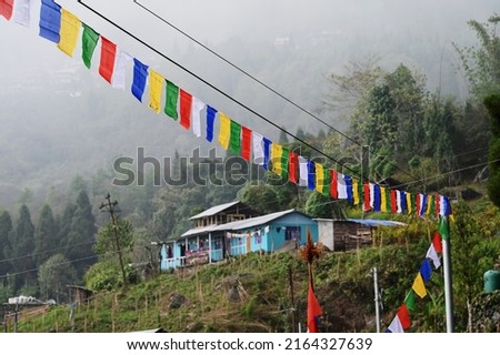 THIS PHOTO HAS BEEN TAKEN ON 5TH APRIL 2022 AT RAMDHURA VILLAGE IN KALIMPONG. SOME COLORFUL FLAGS MADE THIS FOGGY DAY BRIGHT AND UNIQUE.