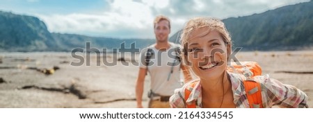 Travel hiking couple hikers happy with backpacks on summer outdoor active adventure vacation. Smiling Asian girl and man hikers banner landscape panoramic Royalty-Free Stock Photo #2164334545