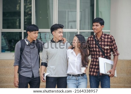Group of Diversity Student talking and laughing together at asian college. Happy multi ethnic friend successfully completes the thesis report and passed final exam in university.