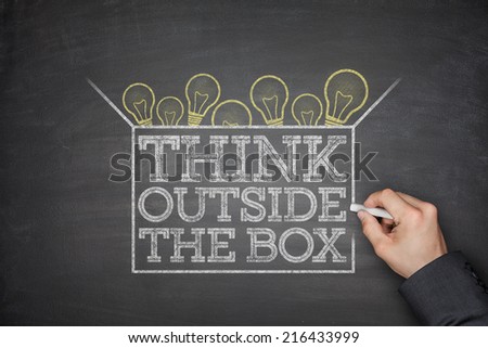 Think outside the box concept on black blackboard
