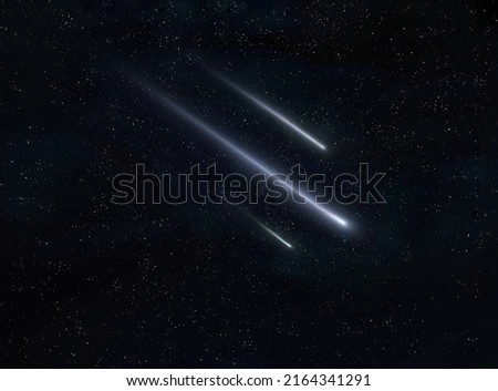 Meteor trails in the night sky, beautiful meteor shower. falling stars. Three meteorites burn up in the atmosphere.