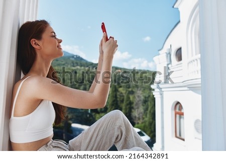 pretty woman with a red phone Terrace outdoor luxury landscape leisure Relaxation concept