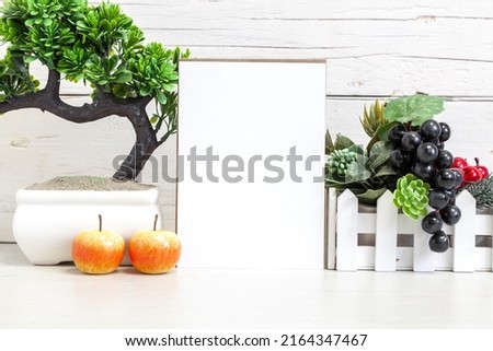 Holiday party invitation mockup. Vertical white card 5x7 on a table with fruits.