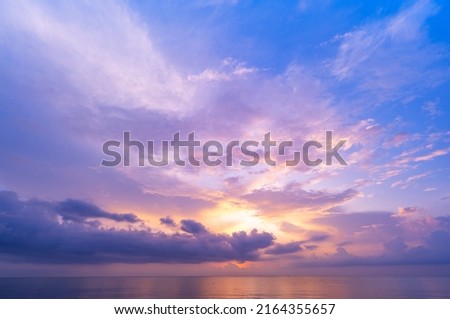 Landscape Long exposure of majestic clouds in the sky sunset or sunrise over sea with reflection in the tropical sea Beautiful seascape scenery Amazing light of nature sunset Royalty-Free Stock Photo #2164355657