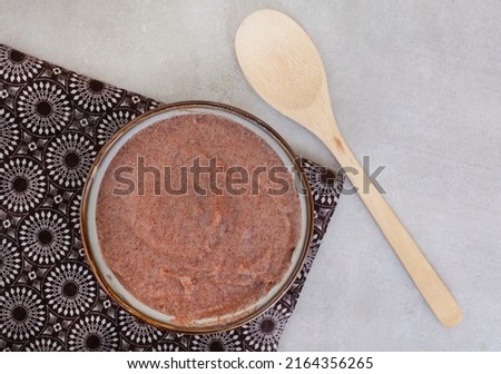 Traditional  African Sorghum breakfast porridge or Mabele, on mottled grey with copy space Royalty-Free Stock Photo #2164356265