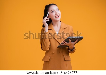 casual smart asian female business woman hand using tablet business management schedule smiling confident cheerful facial expression studio shot yellow background,thinking asian woman in formal cloth Royalty-Free Stock Photo #2164362771