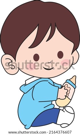 A little boy sitting and holding a bottle of milk. little boy drinking milk