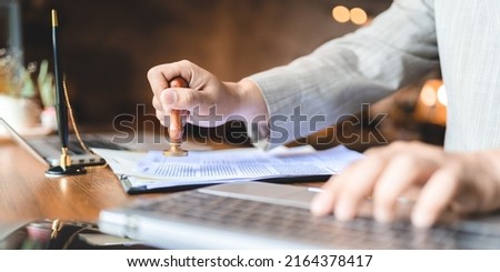 business approve and certificate concept, confirmation of business marketing document permit and certified stamping, signing on business partner paper to success, or concept of attorney and insurance Royalty-Free Stock Photo #2164378417
