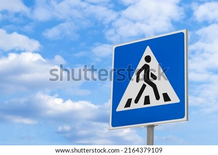 Post with Pedestrian Crossing traffic sign against blue sky on sunny day. Space for text