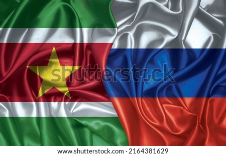 Suriname and Russian two folded silk flags together.