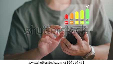 Customer using smartphone with face icons and info graphic percentage to evaluate product after use service , customer satisfaction concept.