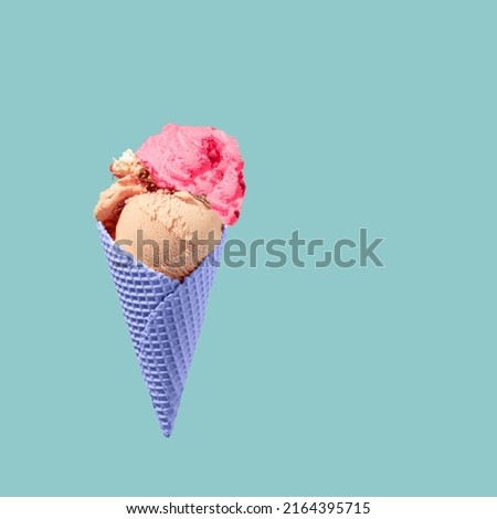 Flying or levitating waffles purple cornet , with strawberry ice cream and  blue background.Summer creative copy space made of waffle cone and ice cream strawberry and cokolade