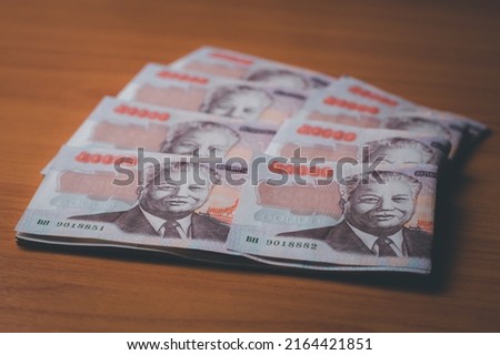 Closeup shot of Lao KIP currency , exchange and banking concept, on the wood background