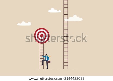 Focus on short term goal to achieve long term success, business strategy or planning, financial goal or project plan concept, smart businessman about to climb up ladder to achieve short term goal. Royalty-Free Stock Photo #2164422033