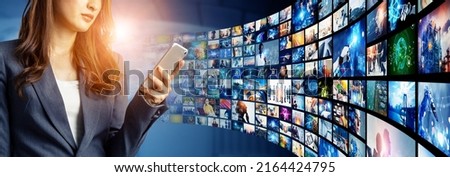 Woman watching movies with a smart phone. Digital contents concept. Social networking service. Streaming video. NFT. Non-fungible token. Wide angle visual for banners or  advertisements.
