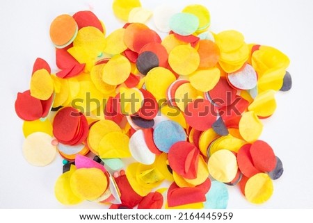 Colored abstract polka dot confetti flatlay on white background