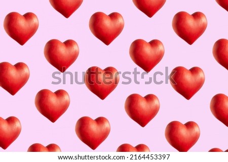Big red 3d hearts, cute pattern against pastel pink background. Love concept, wallpaper. 