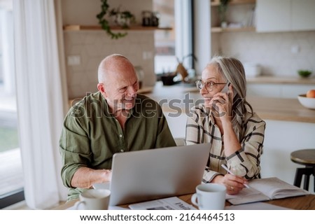 Happy senior couple calculate expenses or planning budget together at home. Royalty-Free Stock Photo #2164464513