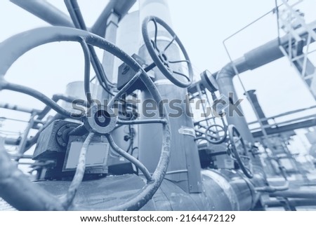 Concept background industrial factory zone. Steel pipelines, valves and ladders modern gas power plant.