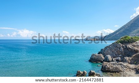 Seascape. Rocky seashore with clouds on the horizon