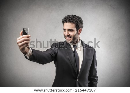 Businessman taking a picture of himself