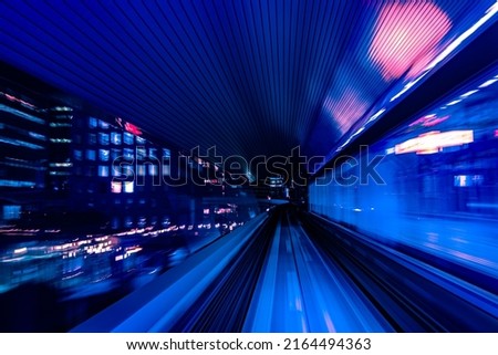 Long exposure motion blur from Yurikamome Monorail line in Tokyo, Japan. Abstract for Digital, Metaverse Technology, Futuristic Transportation, Computer Network, and Communication concept. Royalty-Free Stock Photo #2164494363