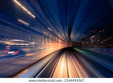 Long exposure motion blur from Yurikamome Monorail line in Tokyo, Japan. Abstract for Digital, Metaverse Technology, Futuristic Transportation, Computer Network, and Communication concept. Royalty-Free Stock Photo #2164494367