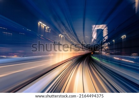 Long exposure motion blur from Yurikamome Monorail line in Tokyo, Japan. Abstract for Digital, Metaverse Technology, Futuristic Transportation, Computer Network, and Communication concept. Royalty-Free Stock Photo #2164494375