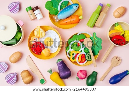 Cute kids toys to play in the kitchen. Wooden fruit and vegetables play set. Educational toys. Healthy food concept. Learning and development of the child