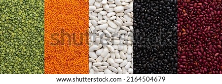 Different types of legumes banner, lentils and green peas, red, white and black beans, top view Royalty-Free Stock Photo #2164504679