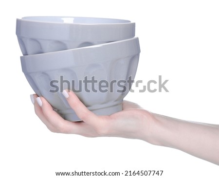 Gray soup plates in hand on white background isolation