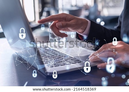 A programmer is typing a code on computer to protect a cyber security from hacker attacks and save clients confidential data. Padlock Hologram icons over the typing hands. Formal wear.