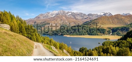 The hiking trail from Plaun da Lej to Grevasalvas (part of via engiadina) offers great views on Lake Sils and the Upper Engadine Valley (Switzerland). Royalty-Free Stock Photo #2164524691