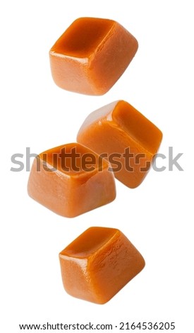 Flying caramel cubes isolated on white background. Set of caramel candies. Royalty-Free Stock Photo #2164536205