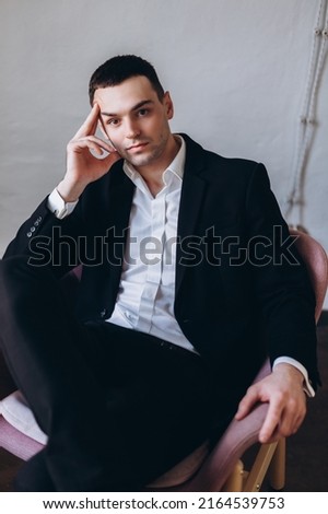 Handsome businessman in fashion suit alone in studio. Expressive young man concept