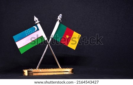 Uzbekistan and Cameroon table flag with black Background